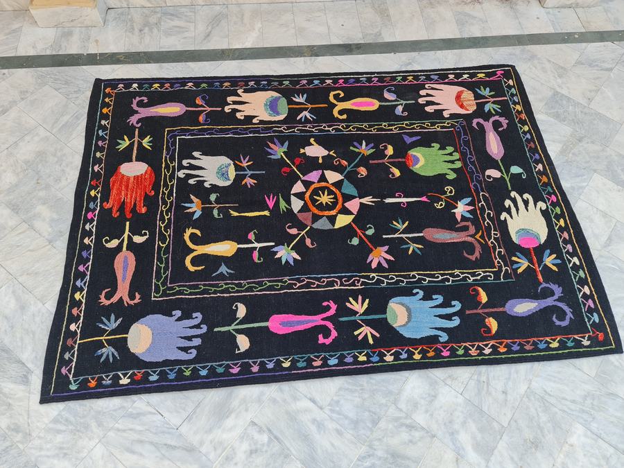 Hand-embroidered rug in black, woven in our Lahore workshop