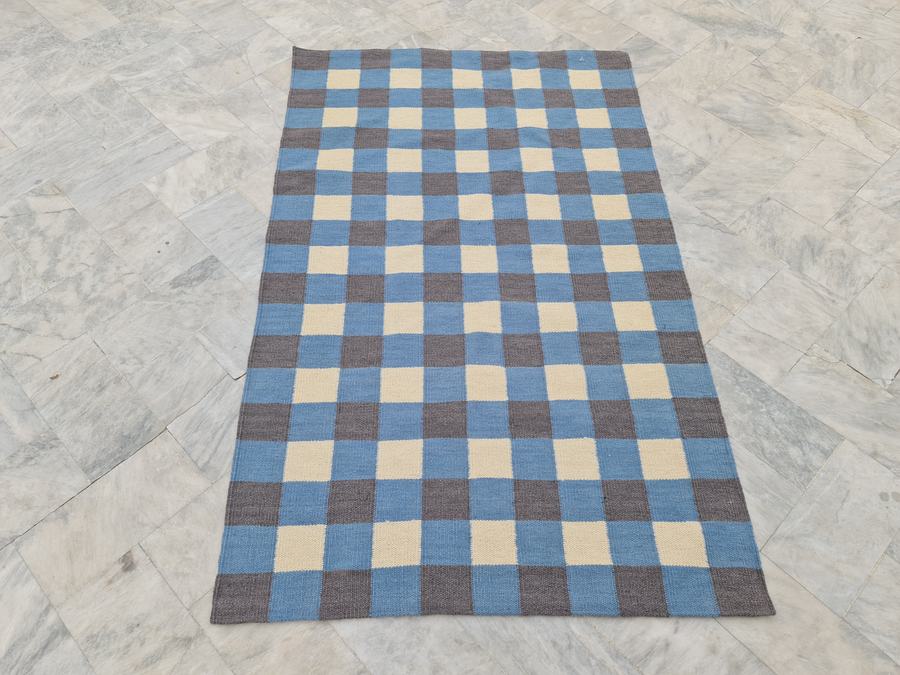Flatweave kilim rug with a checkered design in blue and grey, woven to order