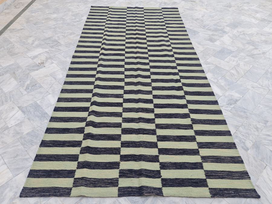 Flatweave kilim rug with a striped design in green and black, woven to order