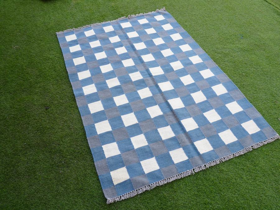 Flatweave kilim rug with a checkered design in grey and blue, woven in our Lahore workshop