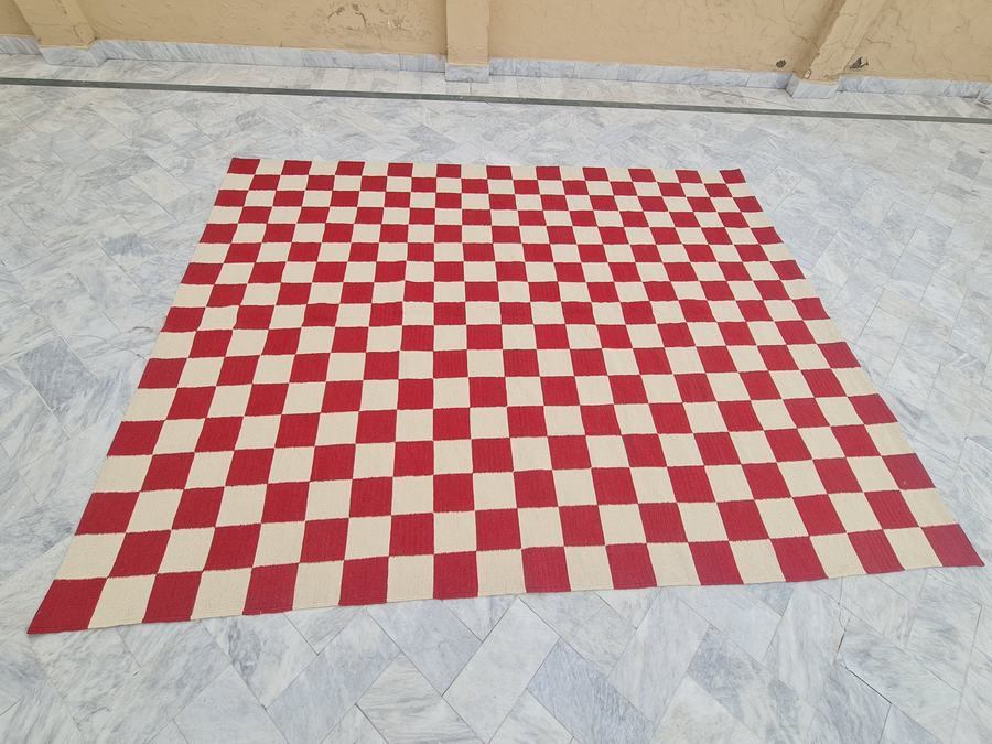 Custom flatweave kilim rug with a checkered design in red and white, handwoven in any size or colour