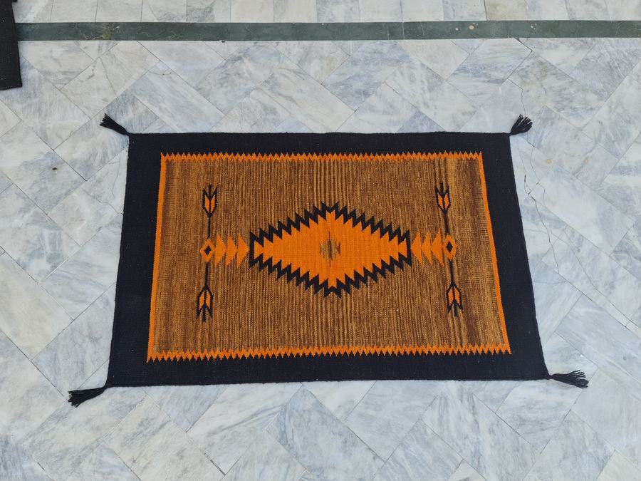 Southwestern flatweave rug in orange and black, made to the customer's measurements