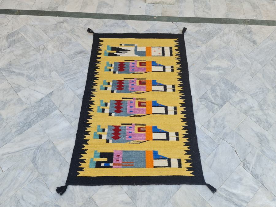 Southwestern flatweave rug with a pictorial design in yellow, handwoven on our own looms